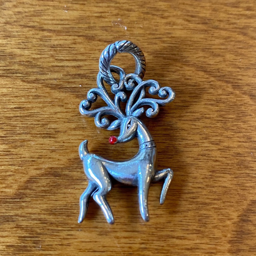 Silver colored reindeer charm.